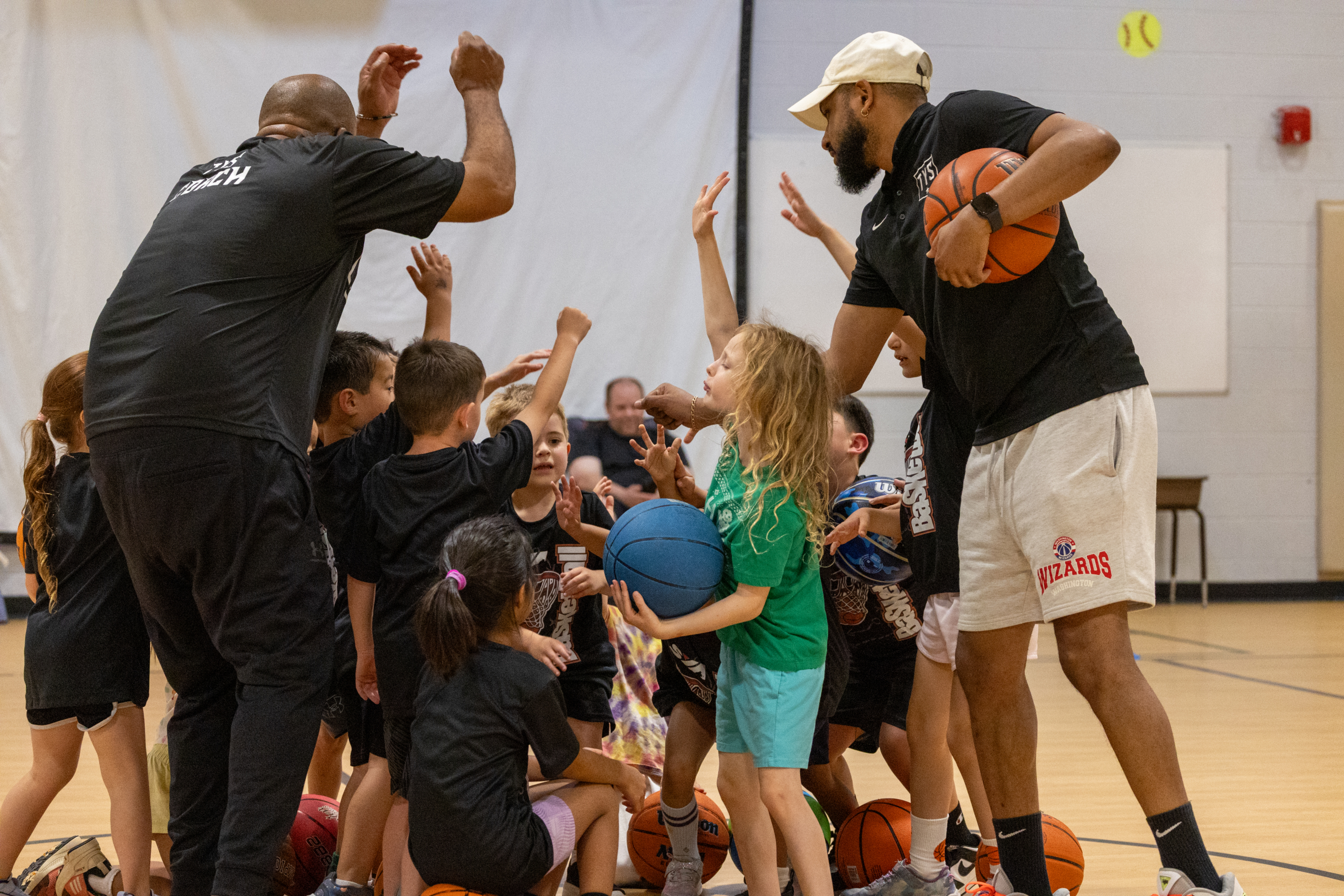 SYA youth sports players celebrating together with a team high-five.