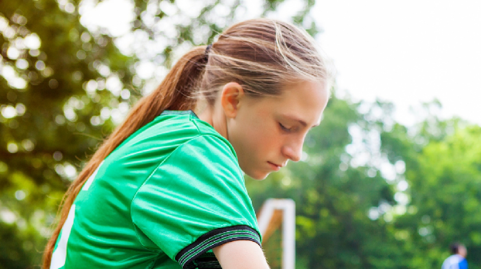 girl wearing a green jersey