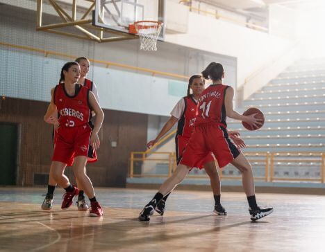 SYA girls playing basketball at a clinic