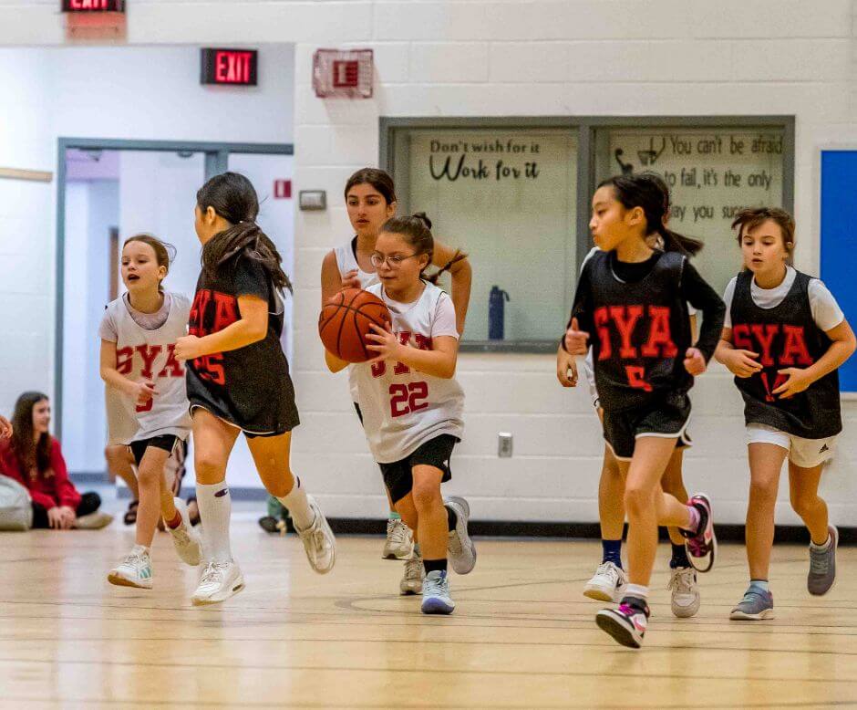 SYA girls basketball players running downt he court