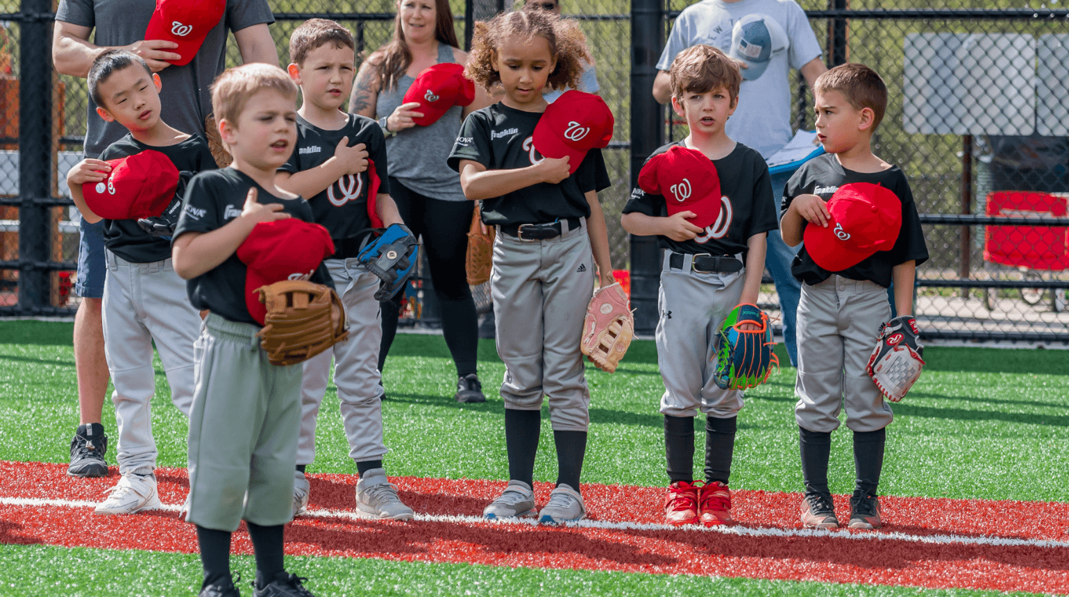 SYA Little League players standing for national anthem