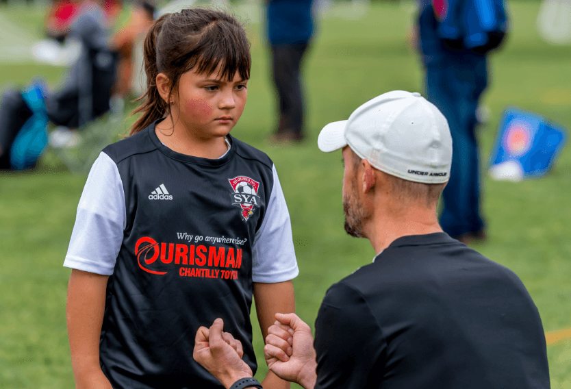 SYA Recreational Soccer Volunteer talking to player