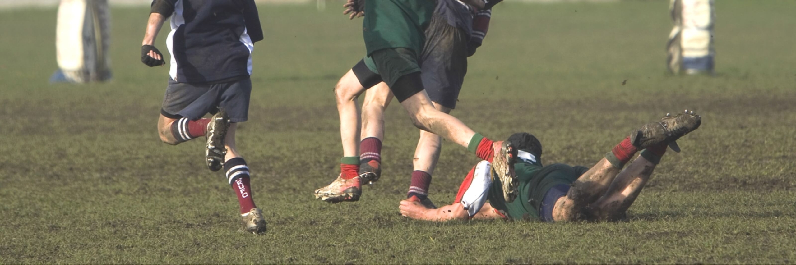 rugby players on a muddy field