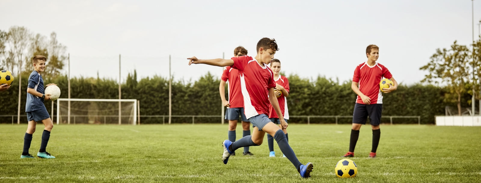 SYA travel soccer players kicking a ball