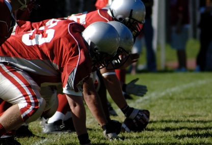 SYA tackle football players in line