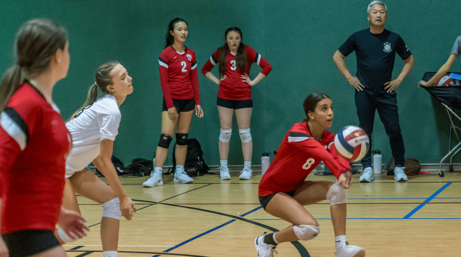 SYA Travel Volleyball player hitting a volleyball