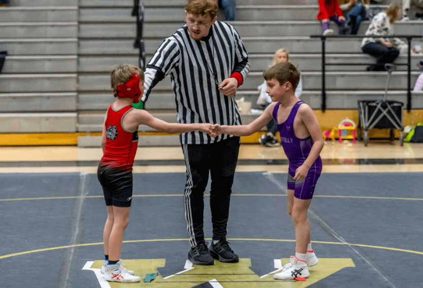 SYA Wrestling Volunteer initiating handshake