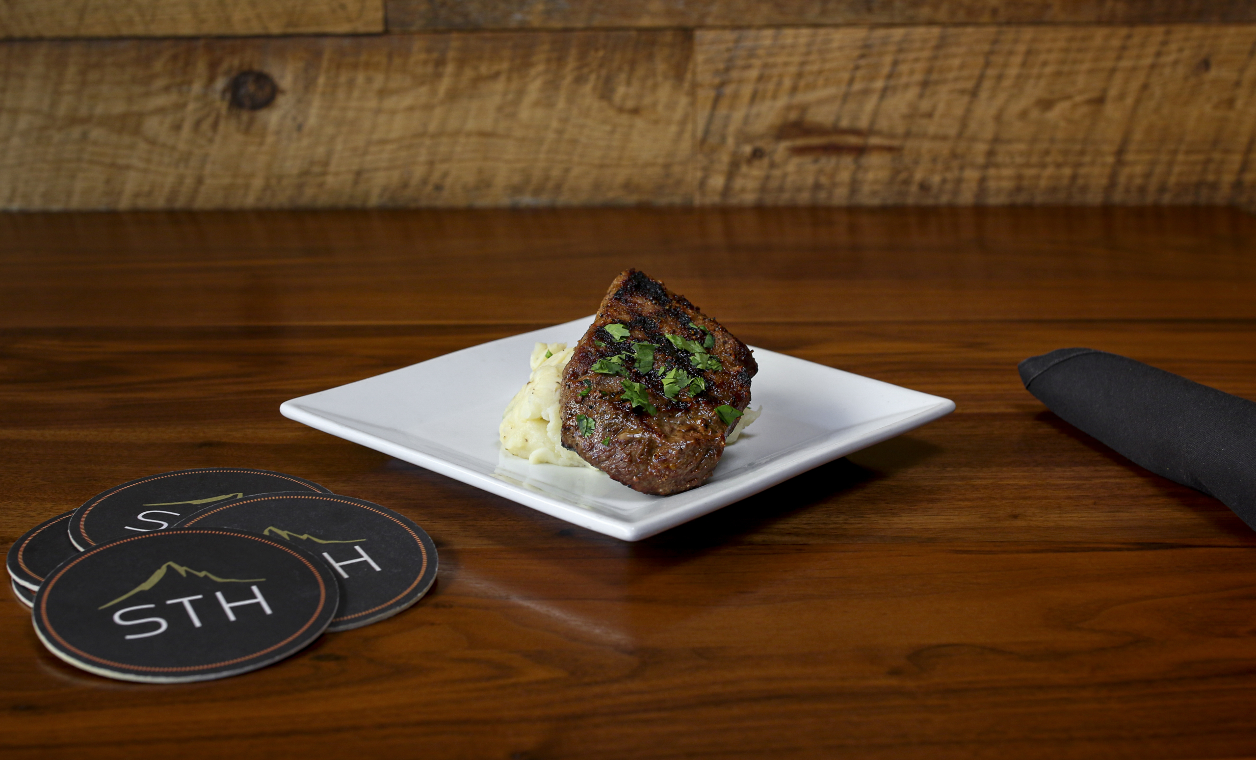steak on a white plate at sedona taphouse